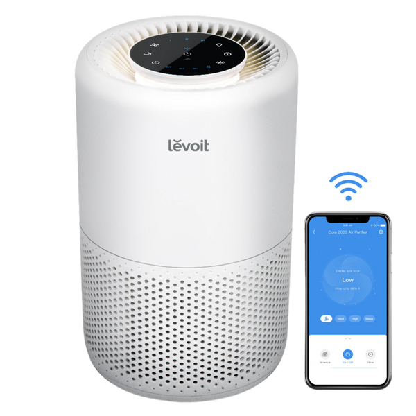 White Levoit Core 200S smart air purifier beside a phone showing the VeSync control app