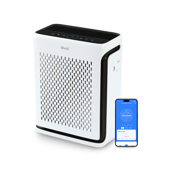 White Levoit Vital 100S Pro air purifier beside a phone displaying the VeSync control app
