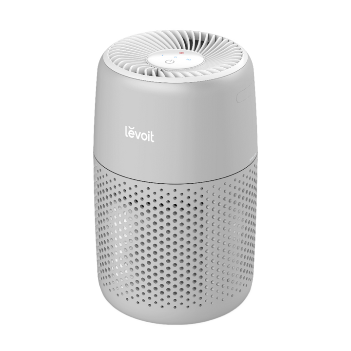 Angled view of white Levoit Core Mini Pro air purifier showing top outlet and perforated base