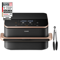 COSORI air fryer in black with rose gold accents, shown with a digital display screen and accompanied by black tongs on a white background. A 'Top Küchen Marke 2025' award badge is visible in the top left corner.