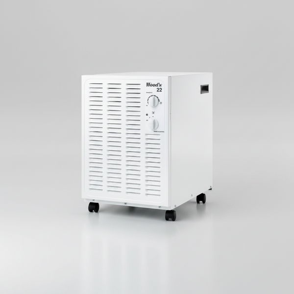 Angled studio view of the white Wood's SW22FW dehumidifier with front air grille, controls and castors.