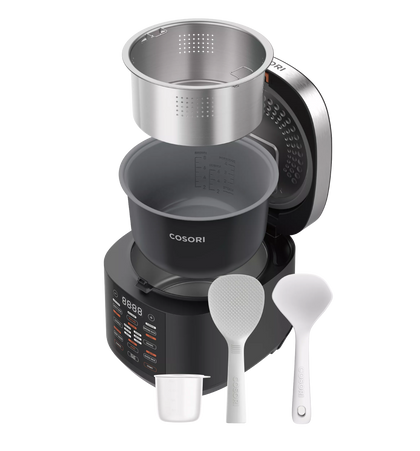 Cosori R-501 with lid open, showing removable inner pot and steamer basket alongside the cup and utensils